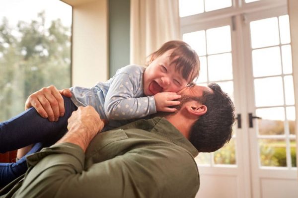 Dad playing with happy downsyndrome toddler